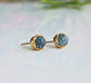 Raw blue diamond stud earrings in gold setting, perfect for bridal or casual wear, radiating timeless beauty.