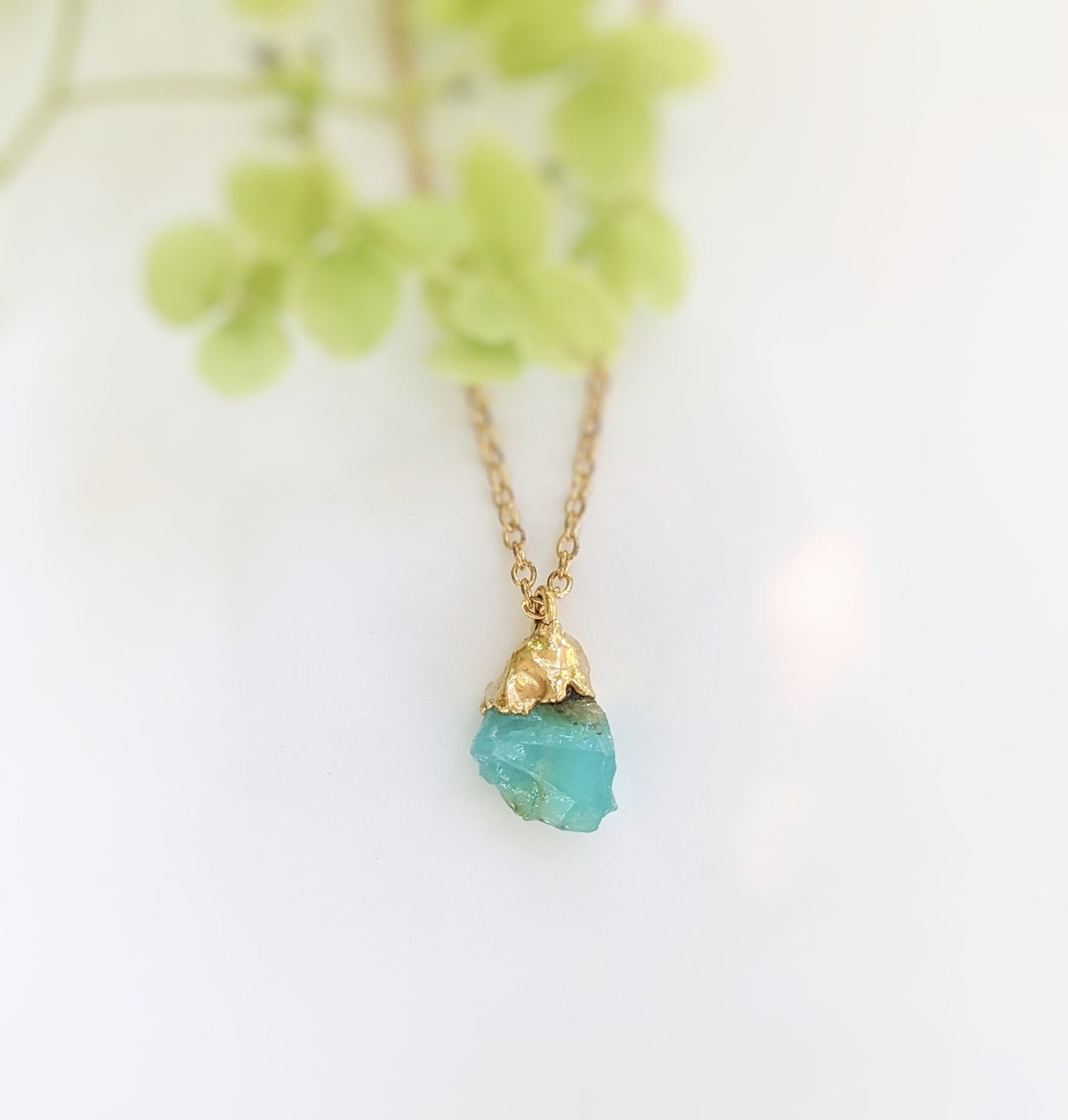 Handcrafted raw crystal necklace featuring a vibrant turquoise gemstone on a gold-filled chain.