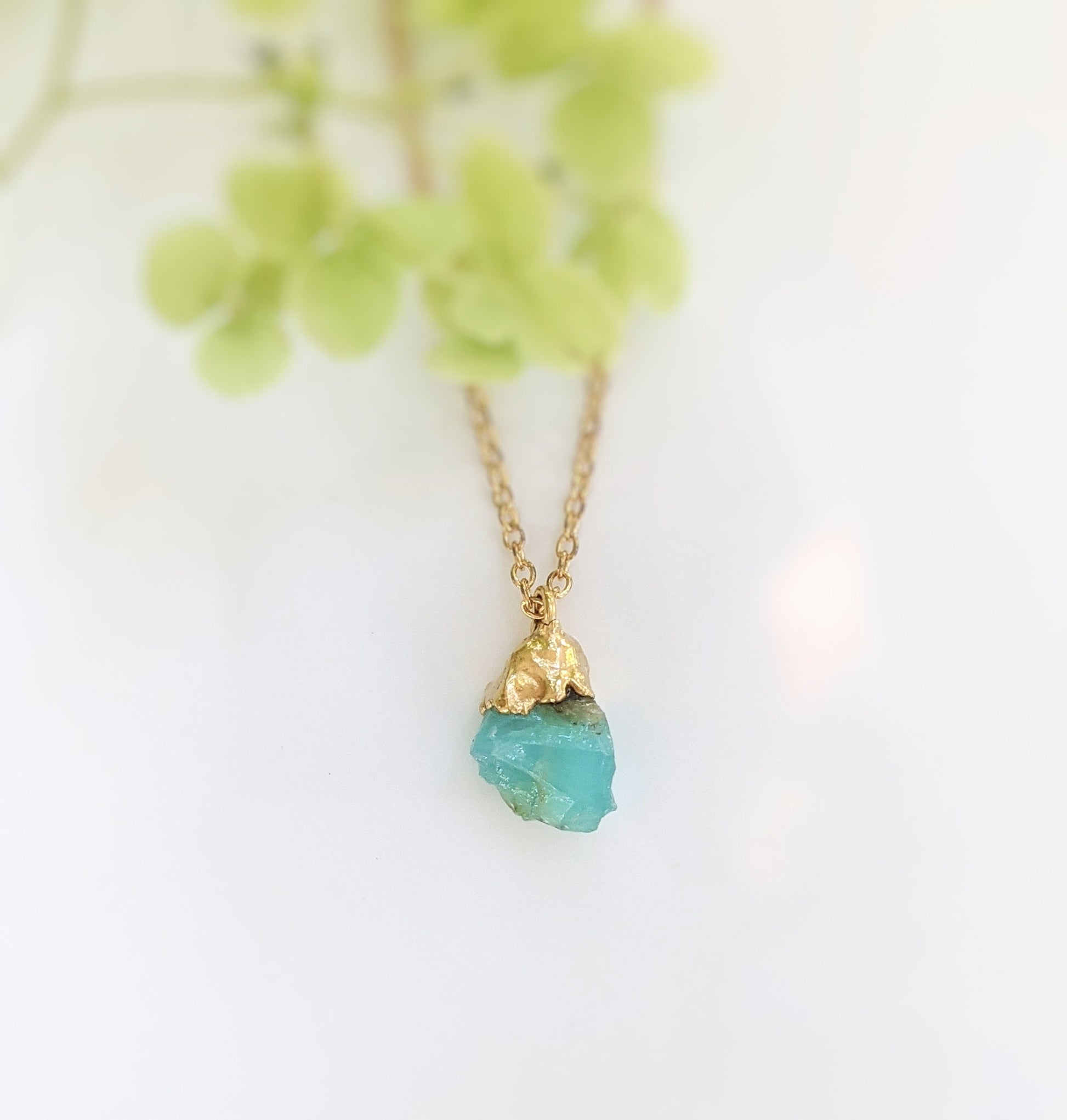 Handcrafted raw crystal necklace featuring a vibrant turquoise gemstone on a gold-filled chain.