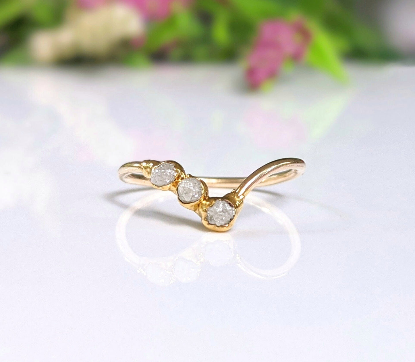 Raw diamond Chevron engagement ring in 18k gold with three conflict-free diamonds, showcasing unique handcrafted design.