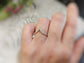 Raw diamond Chevron engagement ring on a hand, showcasing unique design and ethically sourced diamonds.