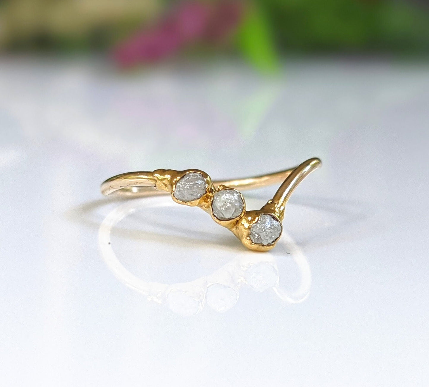 Raw diamond chevron engagement ring in 18k gold featuring three conflict-free diamonds, a unique symbol of love.