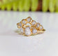 Raw diamond Chevron wedding band with gold setting and seven unique conflict-free diamonds.