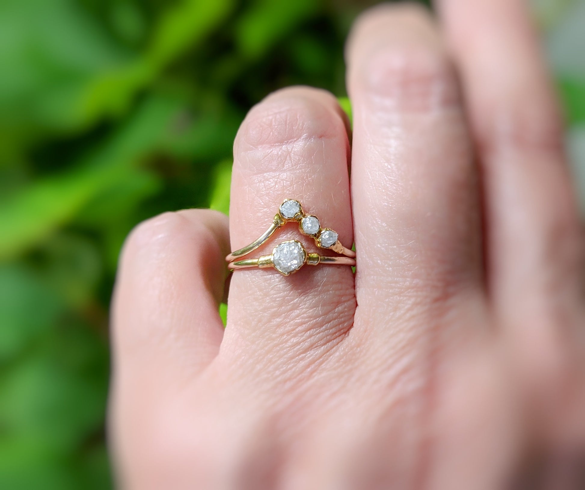 Handmade raw diamond chevron wedding ring set on a hand, featuring uncut diamonds and 18k gold bands.