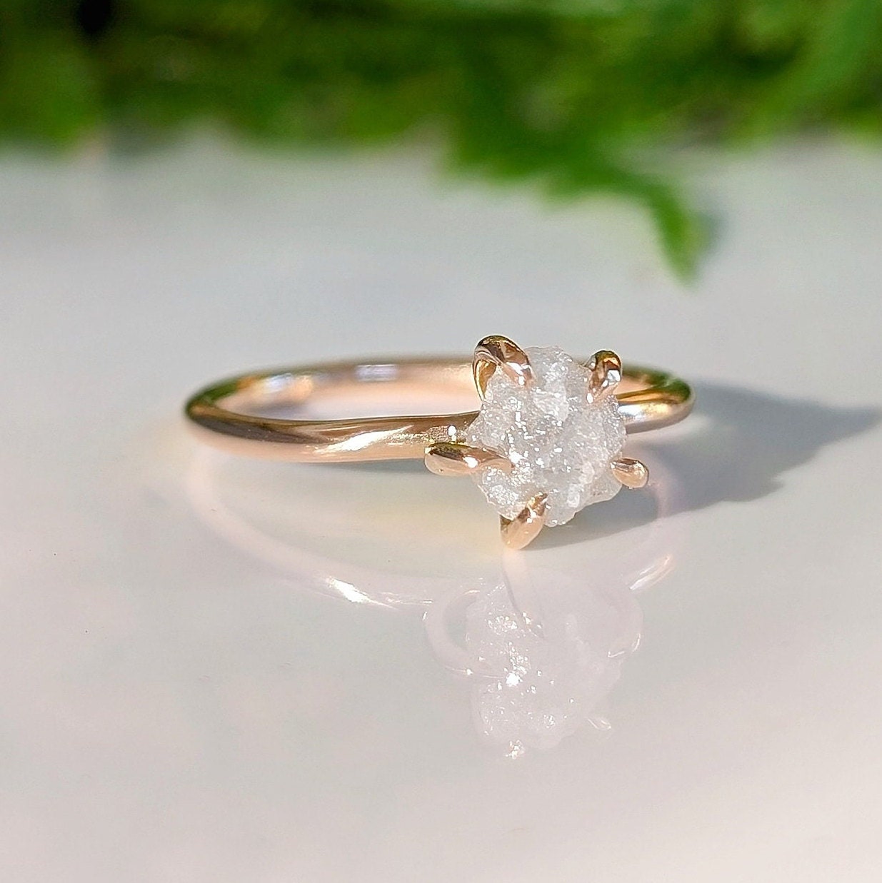 Raw diamond engagement ring in 14k gold setting, showcasing natural beauty and craftsmanship.