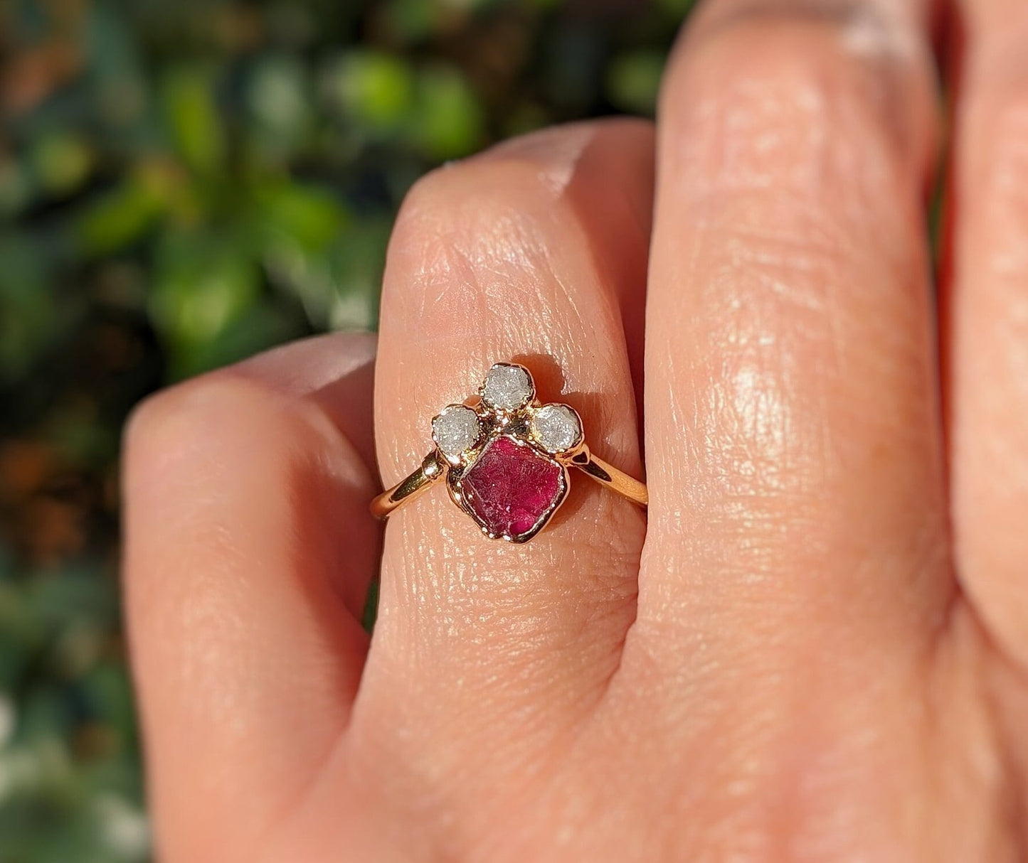 Raw diamond and pink spinel chevron engagement ring showcased on a hand, symbolizing love and elegance.