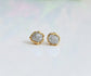 Handcrafted raw diamond stud earrings with gold setting, radiating timeless beauty and elegance.
