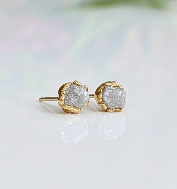Handcrafted raw diamond stud earrings in gold setting, showcasing natural, uncut diamonds with a sparkling finish.