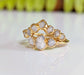 Raw diamond wedding ring set in solid 18k gold with unique organic design and sparkling raw diamonds.