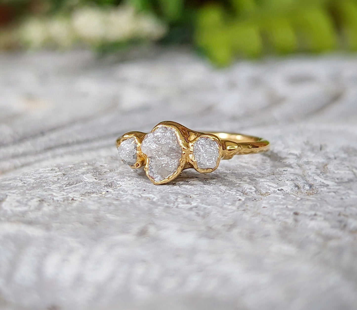 Raw diamond wedding ring set in solid 18k gold featuring three unique raw diamonds.
