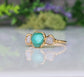 Handcrafted raw emerald and diamond engagement ring with rustic gold setting, symbolizing love and new beginnings.