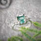 Raw emerald and diamond engagement ring in solid 14k gold, featuring a mint green emerald and conflict-free diamonds.