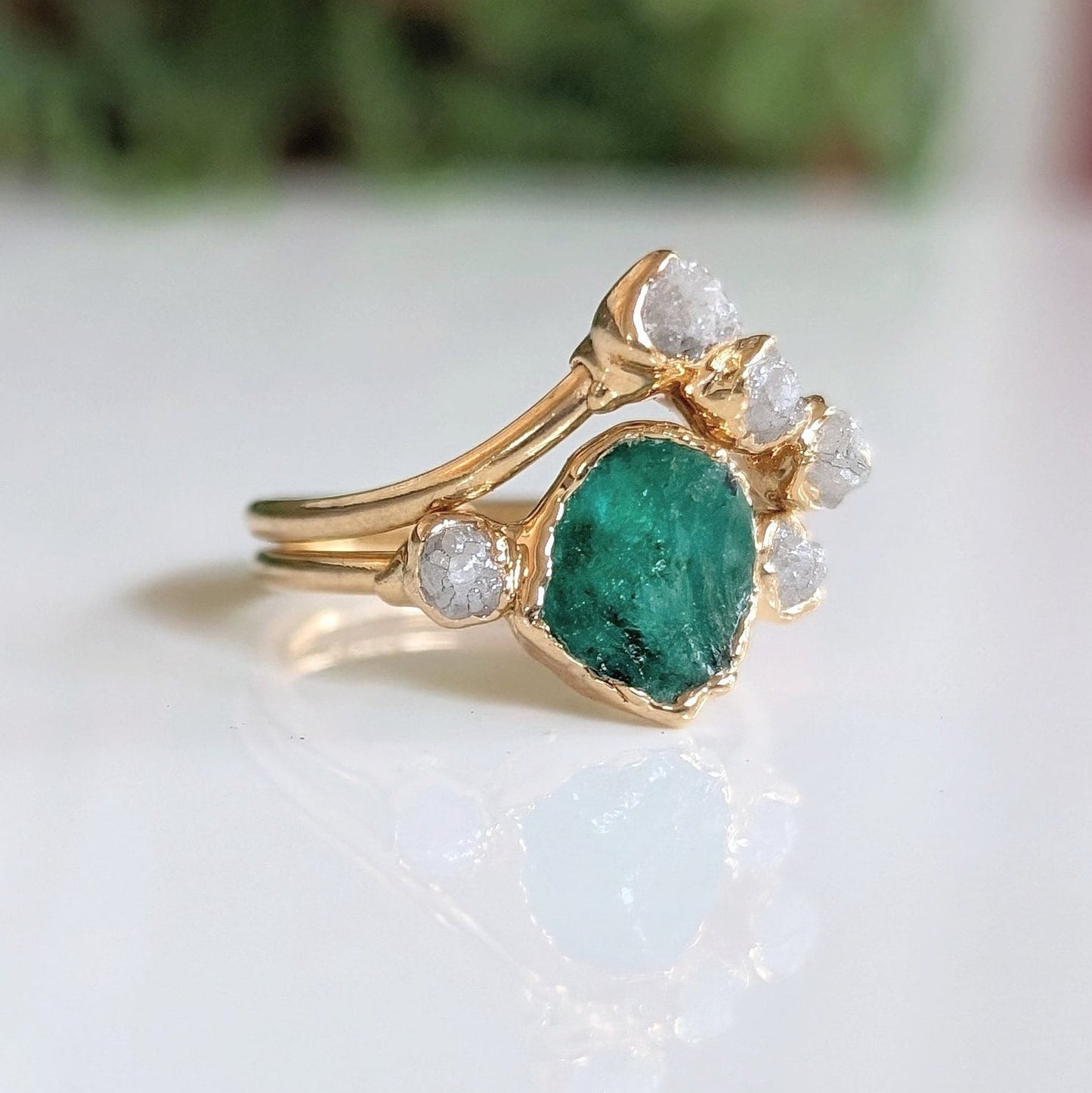 Raw emerald and rough diamond wedding ring set on 18k gold, featuring unique Chevron design.