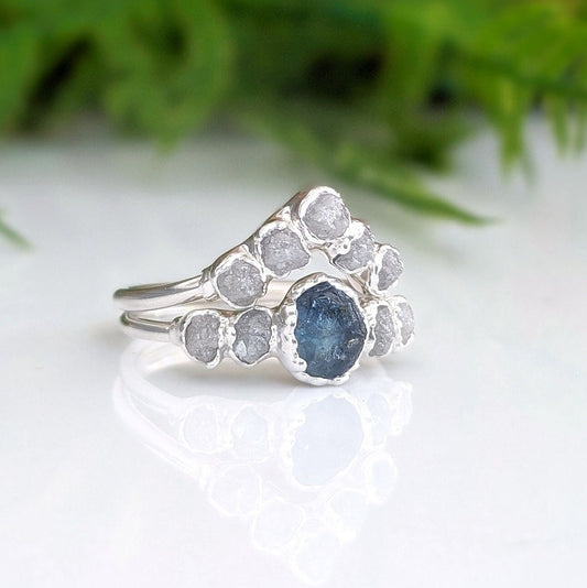 Raw Montana sapphire and diamond bridal ring set in sterling silver, featuring a teal sapphire and raw diamond accents.