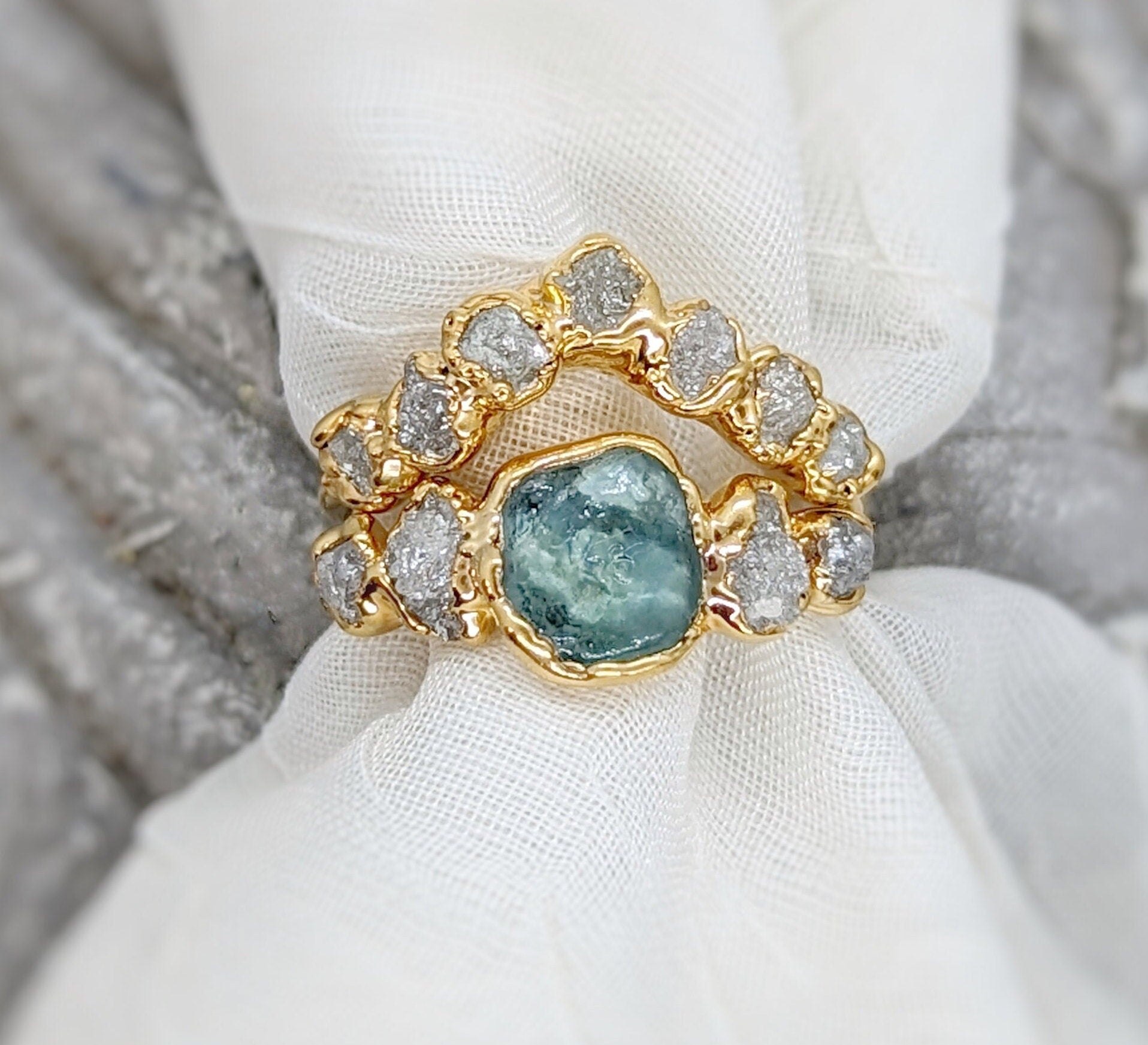 Raw Montana Sapphire and diamond bridal ring set in gold, showcasing unique design and eco-friendly materials.
