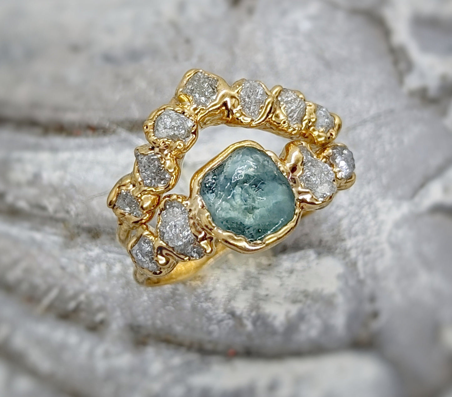Unique raw Montana sapphire and diamond ring set on a solid 14k gold chevron band.