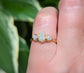 Rustic raw diamond engagement ring on a hand, featuring uncut diamonds on a gold band, perfect for unique proposals.