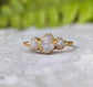 Handcrafted raw diamond engagement ring with three uncut diamonds on a solid gold band.
