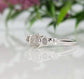 Raw natural diamond engagement ring with a unique design, featuring three stunning diamonds on a silver band.