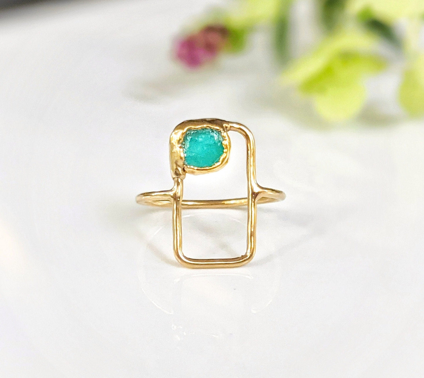 Raw Peruvian opal geometric ring on a gold band, showcasing a unique rectangular design and turquoise stone.