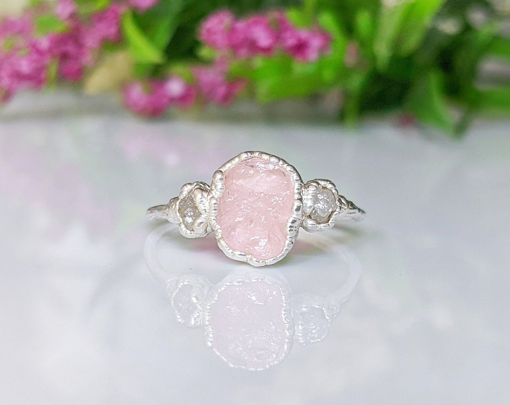 Raw Morganite ring on a sterling silver band showcasing a rough pink Morganite and two natural diamonds.