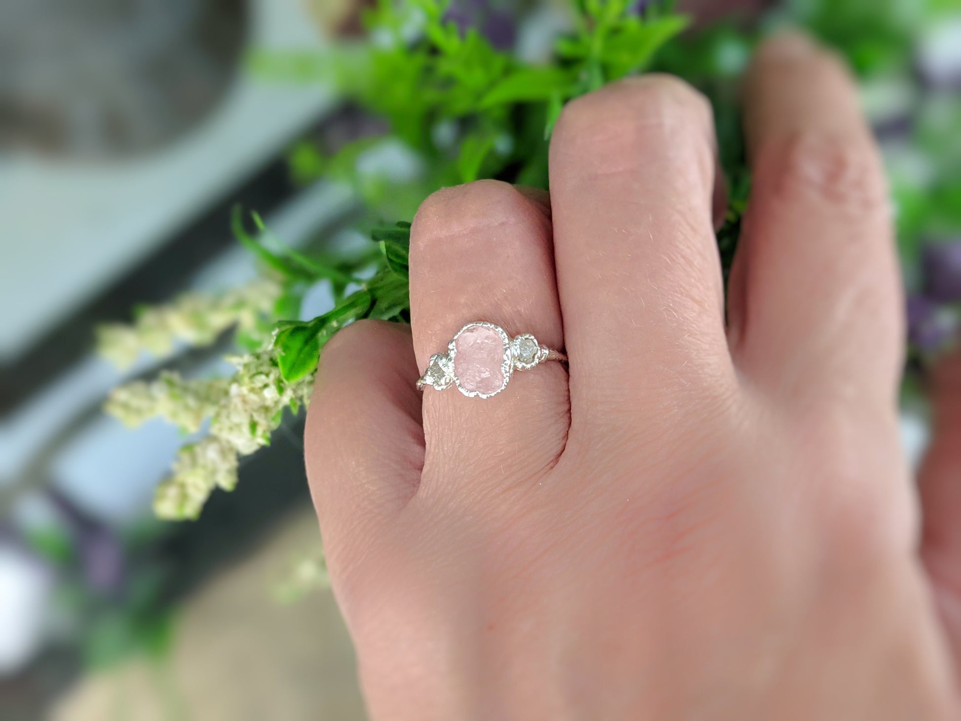 Raw Morganite ring on hand featuring a pink gemstone and rough diamond accents, set on a sterling silver band.