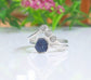 Raw sapphire and diamond chevron wedding ring set on sterling silver bands, showcasing a rustic and timeless design.