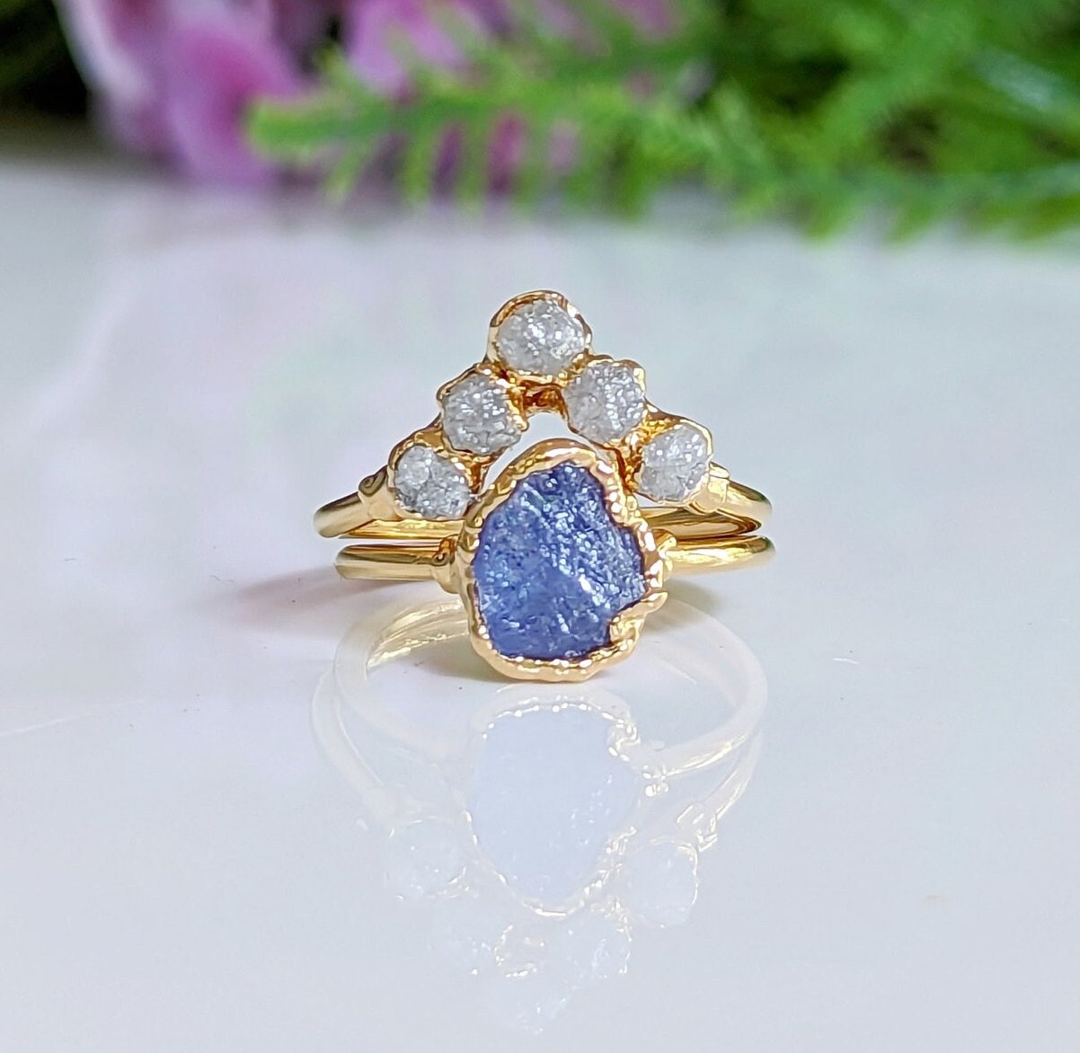 Raw Tanzanite and rough diamond Chevron wedding ring set on a gold band, showcasing unique handcrafted design.