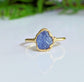 Raw Tanzanite gemstone set in a handcrafted gold ring, showcasing a unique and elegant design.