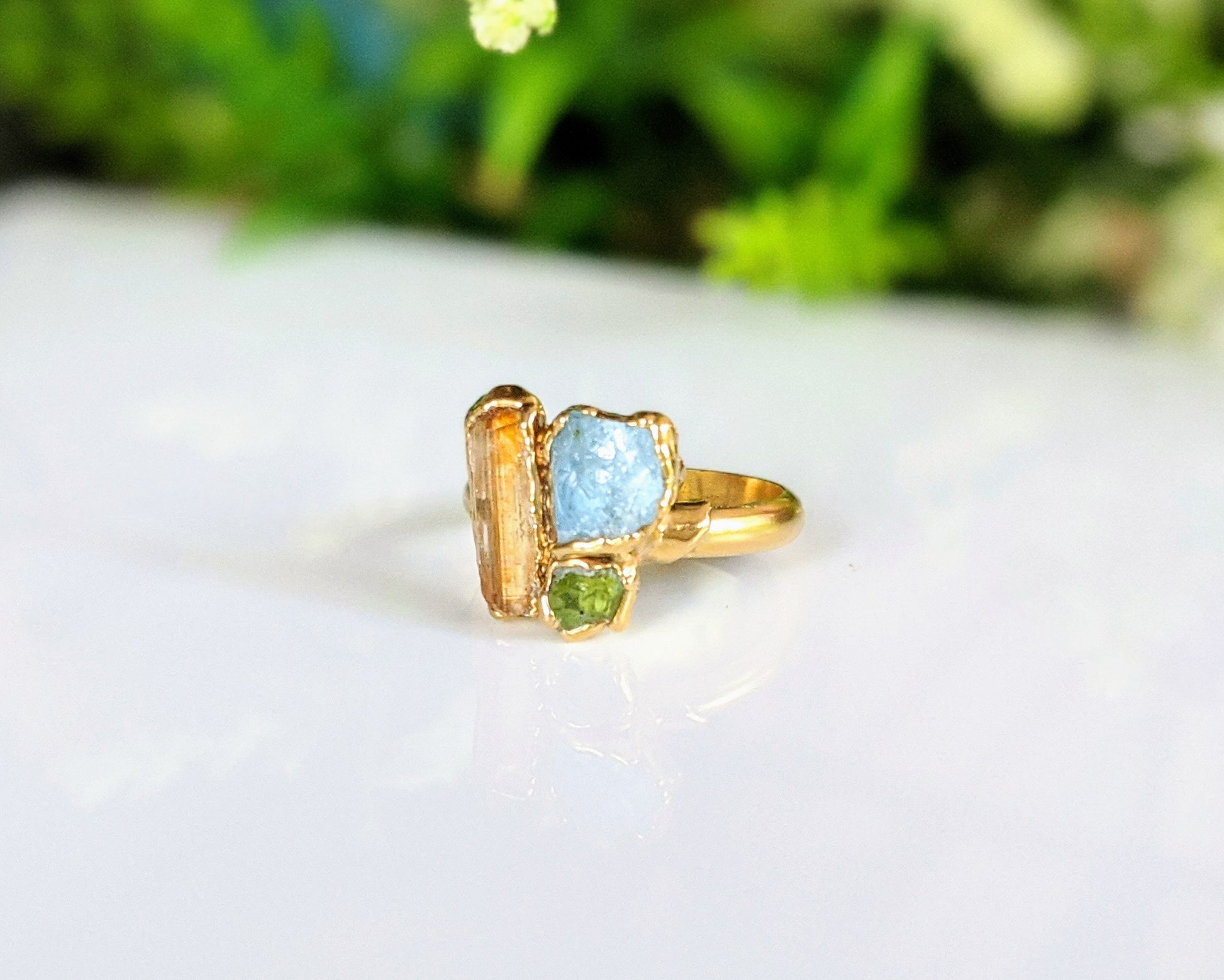 Raw Topaz, Aquamarine, and Peridot cluster ring on a gold filled band, perfect for summer outfits.