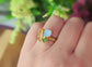 Raw Tourmaline multi-stone cluster ring featuring blue, pink, and green stones on a gold band.