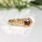 Red Garnet engagement ring set in solid 14k gold, featuring a unique textured band and square-cut stone.