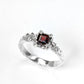 Red Garnet engagement ring in solid sterling silver with an organic textured band and square cut garnet gemstone.