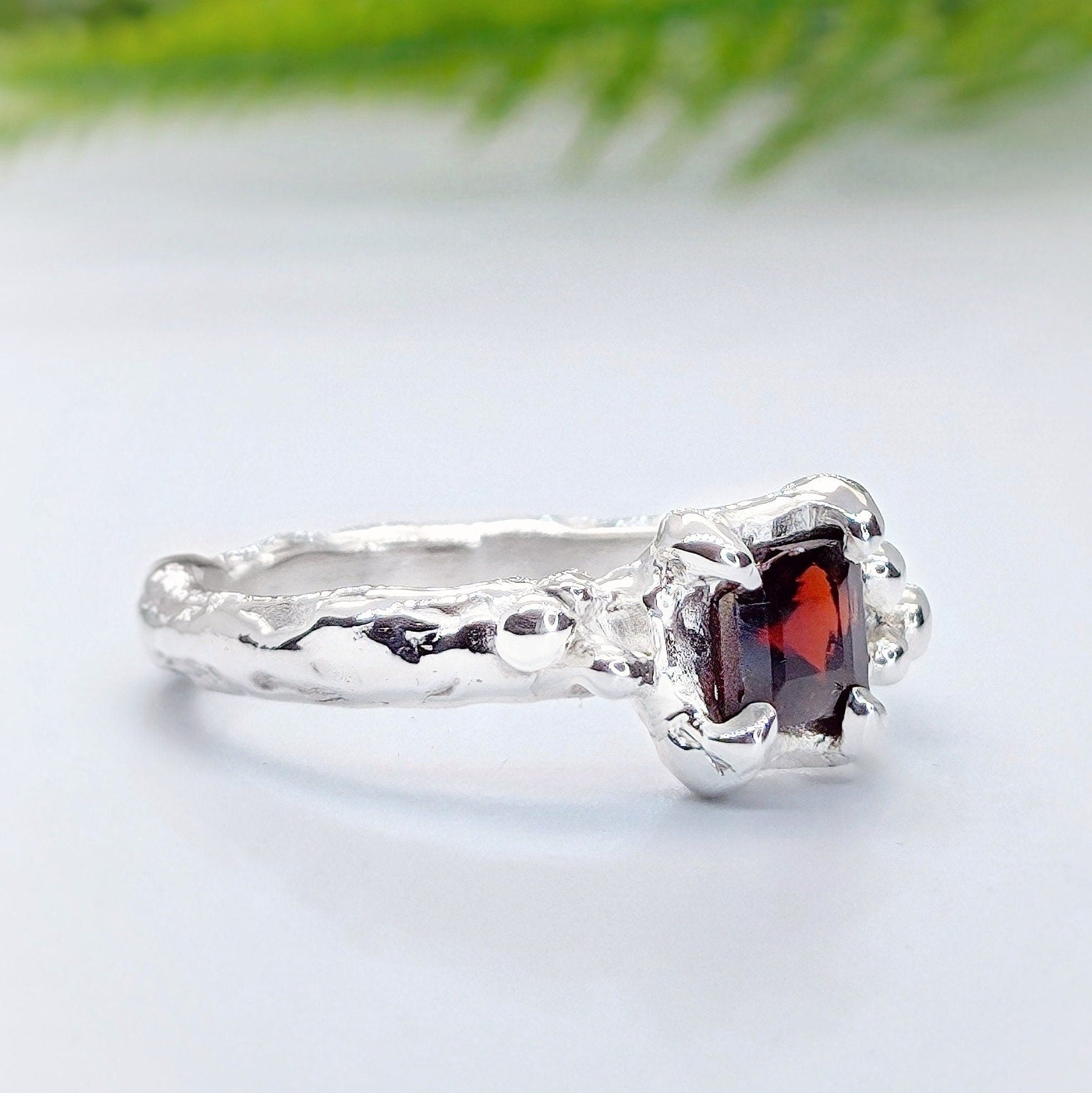Red Garnet engagement ring in solid sterling silver with an organic textured band and square cut gemstone.