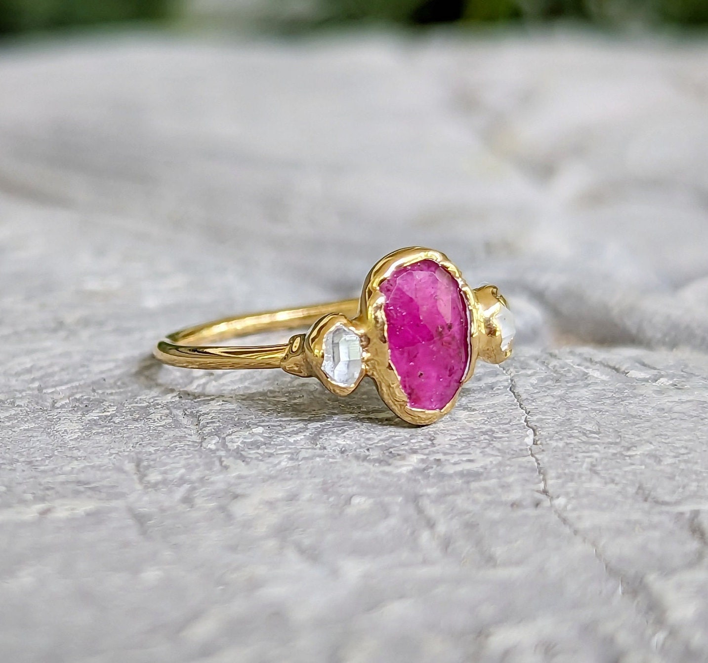 Rubellite tourmaline and diamond engagement ring on a solid gold band, showcasing a unique and handcrafted design.