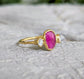 Rubellite tourmaline and diamond engagement ring on a solid gold band, showcasing a unique and handcrafted design.