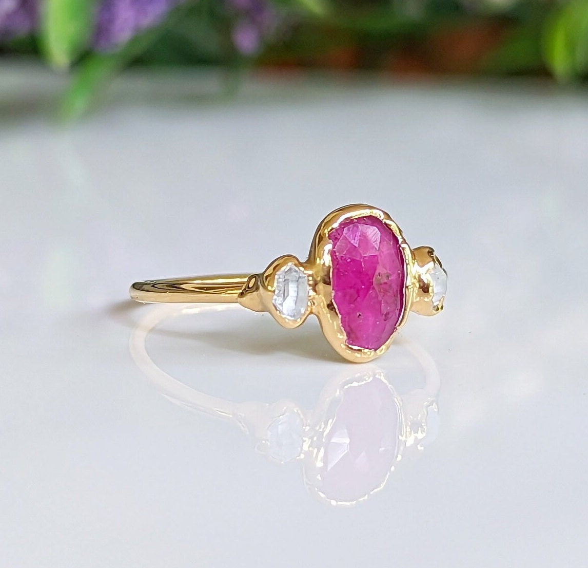 Rubellite Tourmaline and diamond engagement ring on a 14k gold band, showcasing a vibrant pink gemstone.