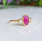 Rubellite Tourmaline and diamond engagement ring on a 14k gold band, showcasing a vibrant pink gemstone.