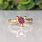 Rubellite tourmaline engagement ring in solid 14k gold with organic textured band and trilliant cut gemstone.