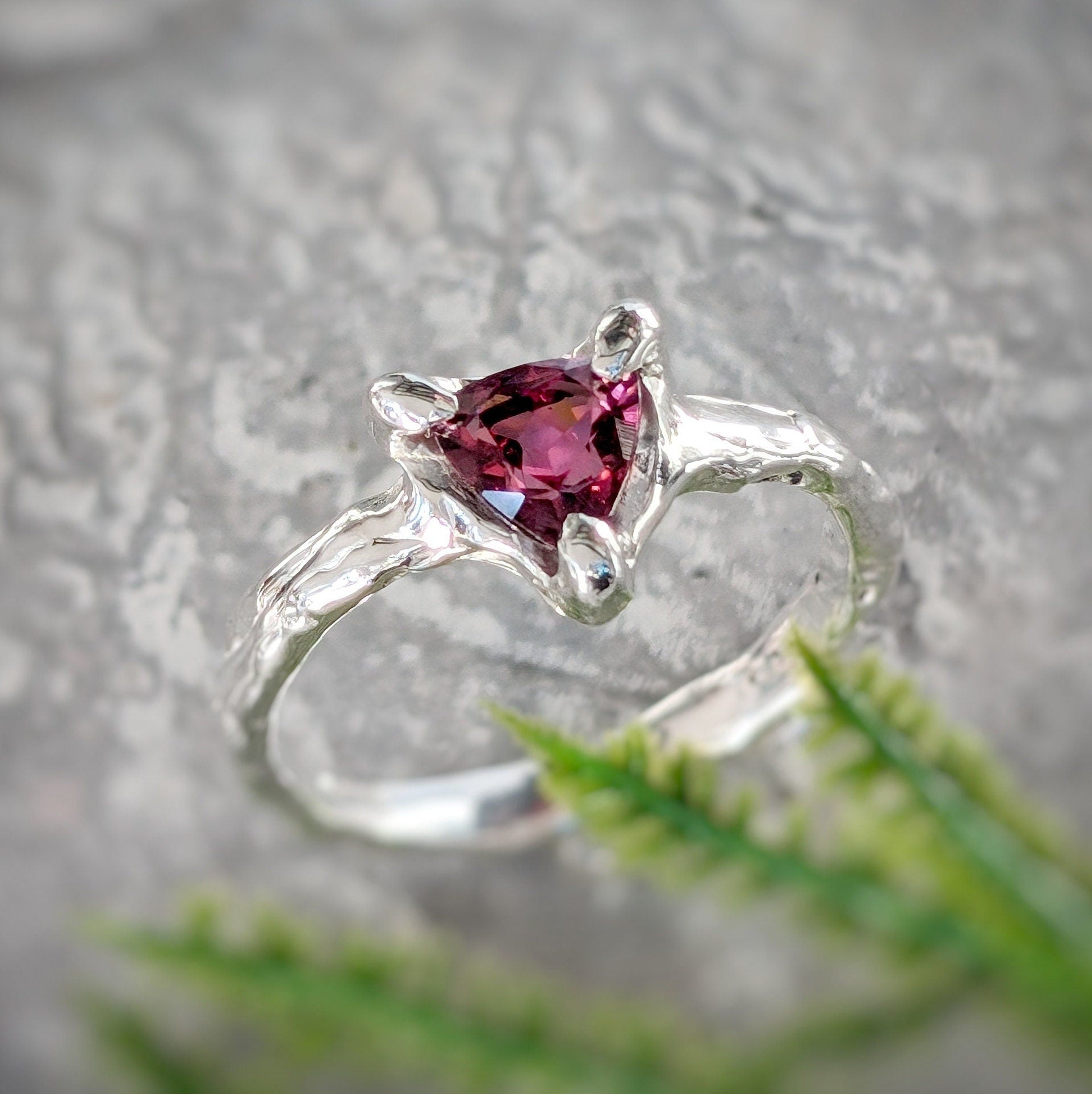 Rubellite Tourmaline engagement ring in solid 14k gold, featuring a trilliant dark pink gemstone on an organic textured band.