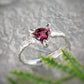 Rubellite Tourmaline engagement ring in solid 14k gold, featuring a trilliant dark pink gemstone on an organic textured band.
