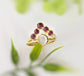 Ruby chevron ring in 18k gold featuring natural rubies and a unique design, perfect for weddings or anniversaries.