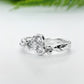 Handcrafted silver CZ cluster ring with organic band and three sparkling cubic zirconia stones.