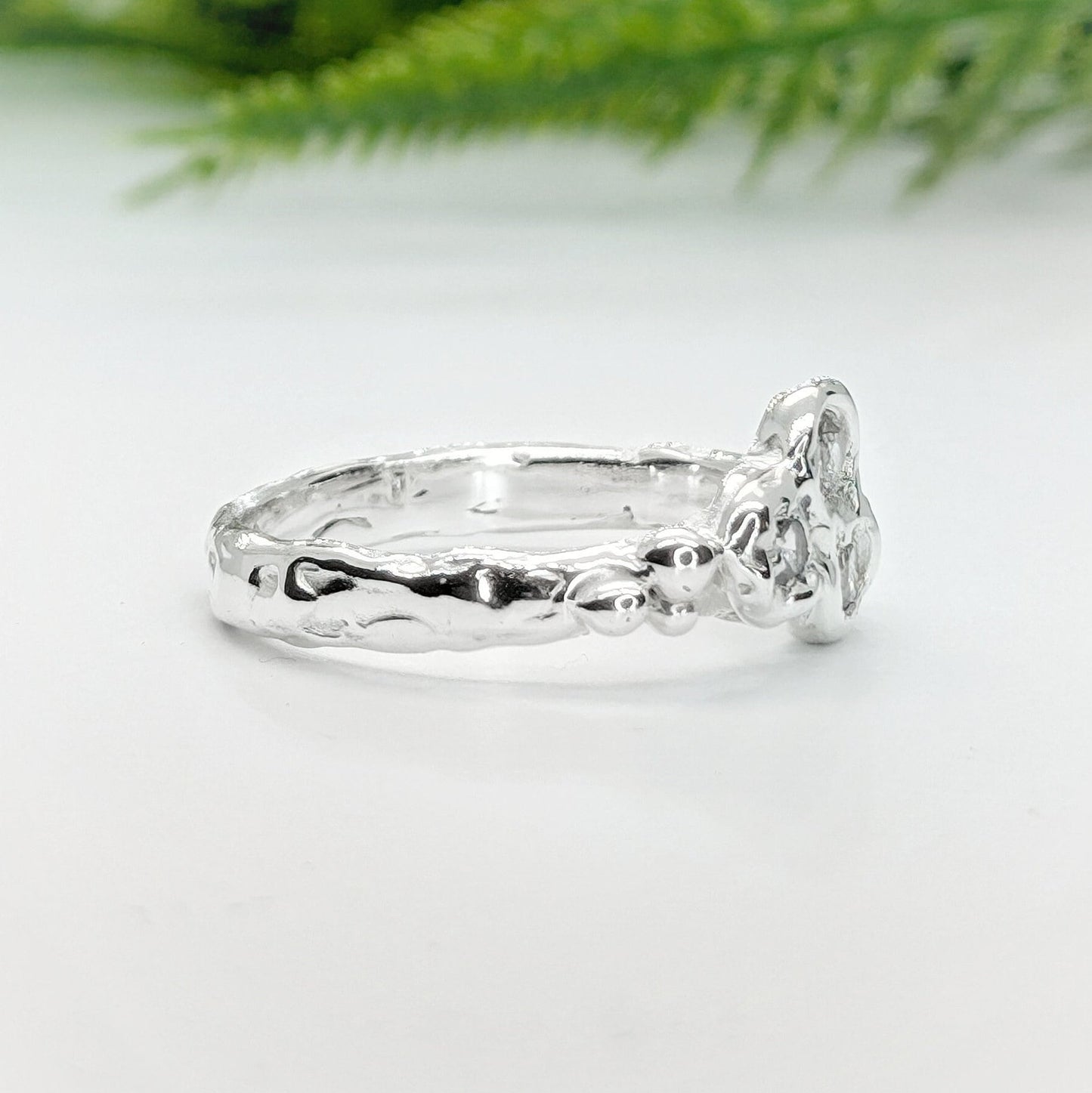 Handcrafted sterling silver cluster ring side view, showcasing organic molten design and sparkling cubic zirconia stones.