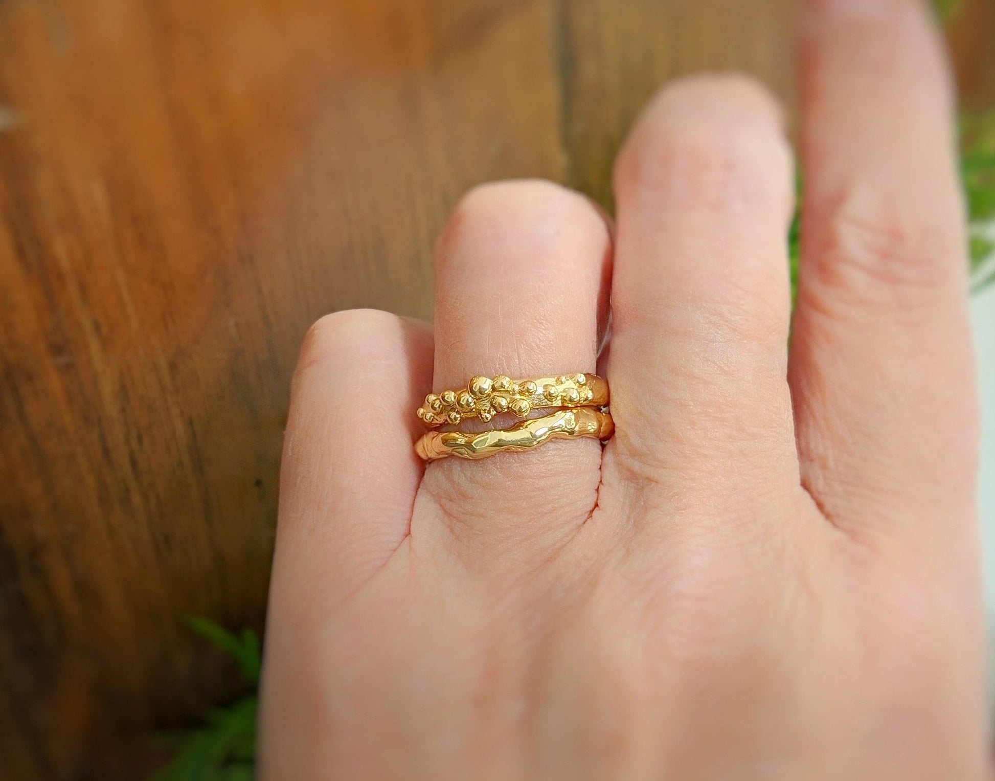 Hand wearing Molten Silver stacking rings showcasing unique, abstract design and nature-inspired beauty.