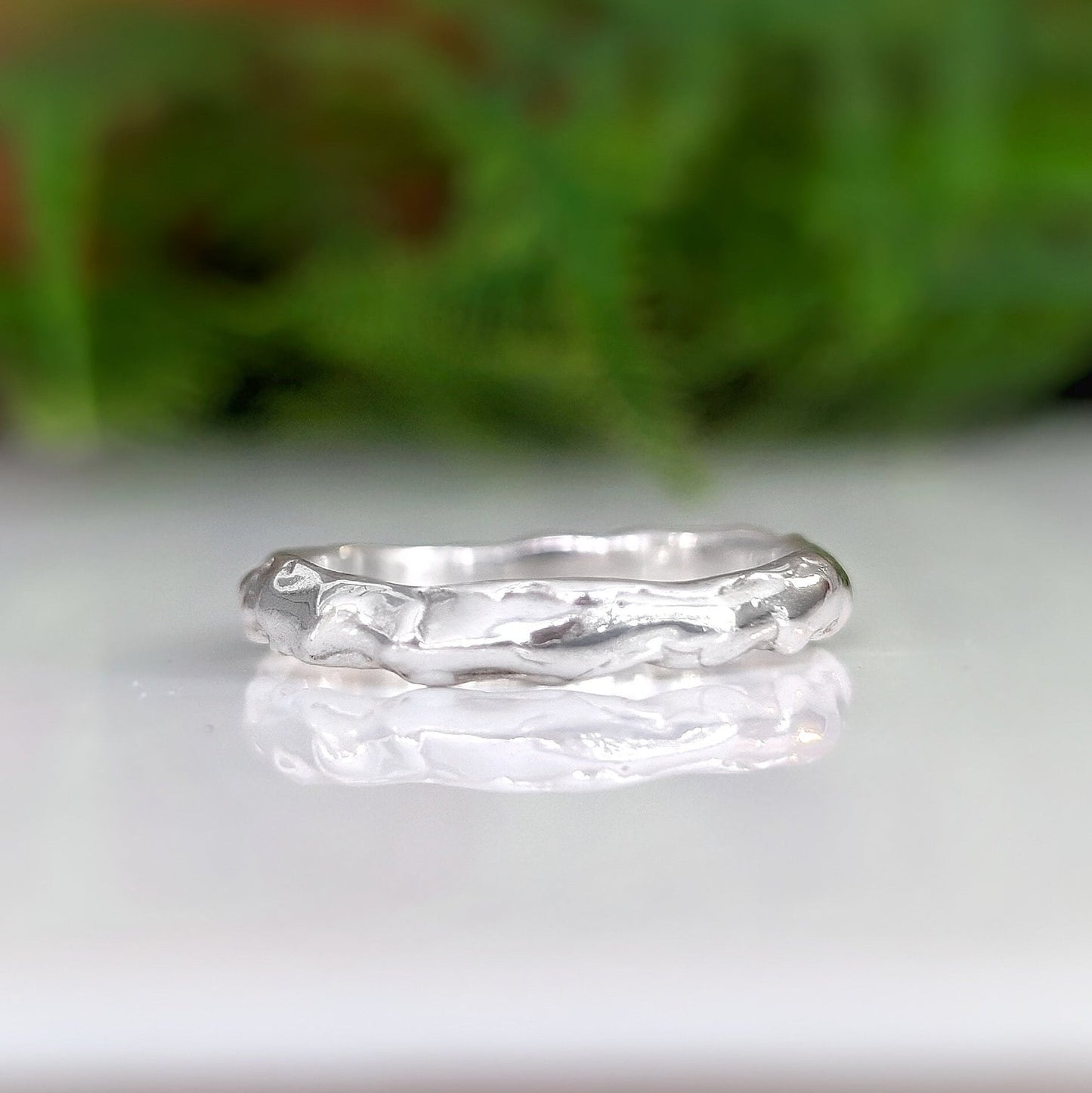 Molten Silver wedding band, handcrafted 14k gold ring with organic texture, symbolizing elegance and individuality.