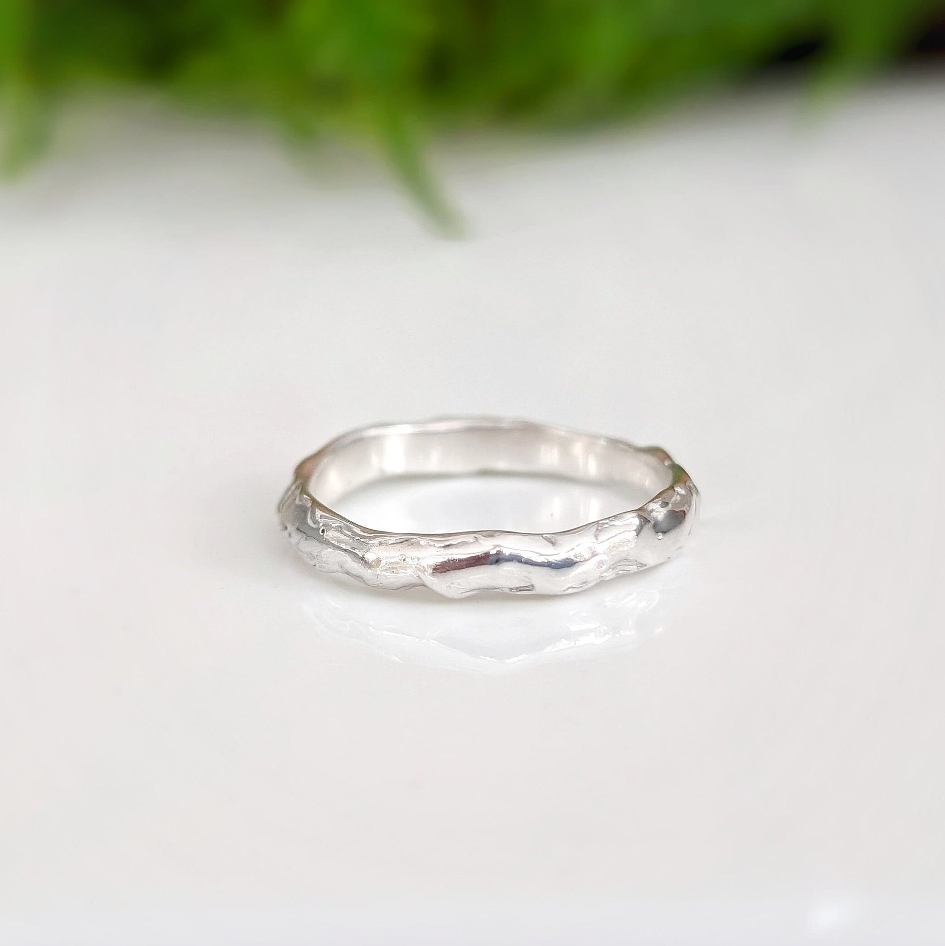 Handcrafted Molten Silver wedding band featuring a unique abstract design, perfect for stacking or as an individual statement ring.