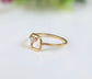 Solid gold minimalist square ring featuring a raw conflict-free diamond on 14k gold band, showcasing unique geometric design.