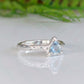 Solid Silver Aquamarine ring with trilliant shape stone on textured band, reflecting love and individuality.