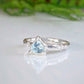 Handcrafted solid silver ring featuring a trilliant shape aquamarine, showcasing a unique organic textured band.